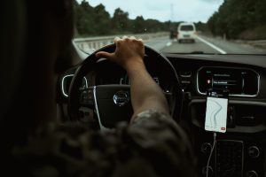 A person driving a car on a highway.